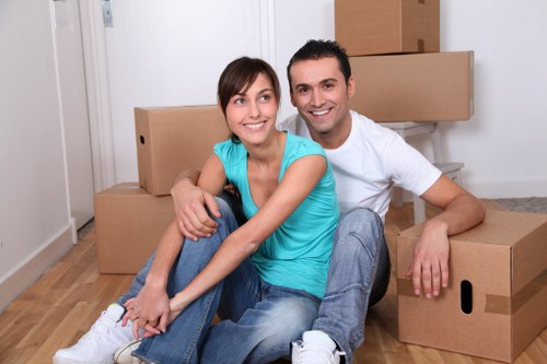 Local removals team handling boxes in Redbridge